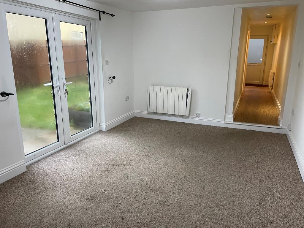 Lot: 136 - DETACHED BUNGALOW IN TOWN CENTRE - View of living room with doors to garden